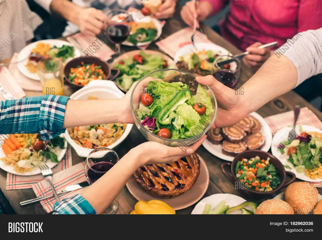 Keluarga makan malam bersama dengan suasana yang hangat